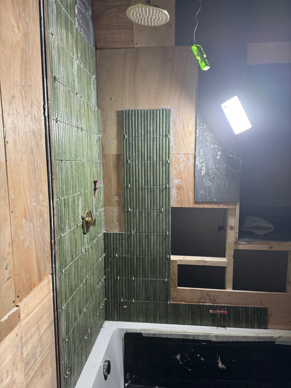 Fresh bathroom fit-out with tiled walls and new brassware in a London home