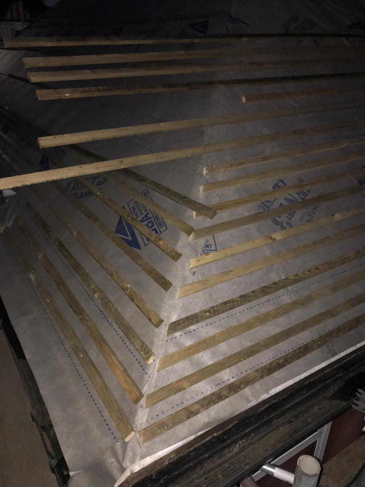 New roofing battens fixed over breathable membrane on a London roof ready for tiling