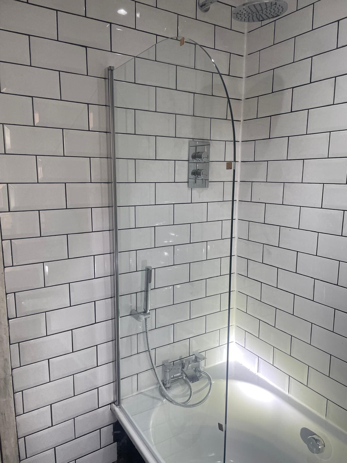 Bathroom installation in progress showing new tiling and fixtures by Refurb Squad in London