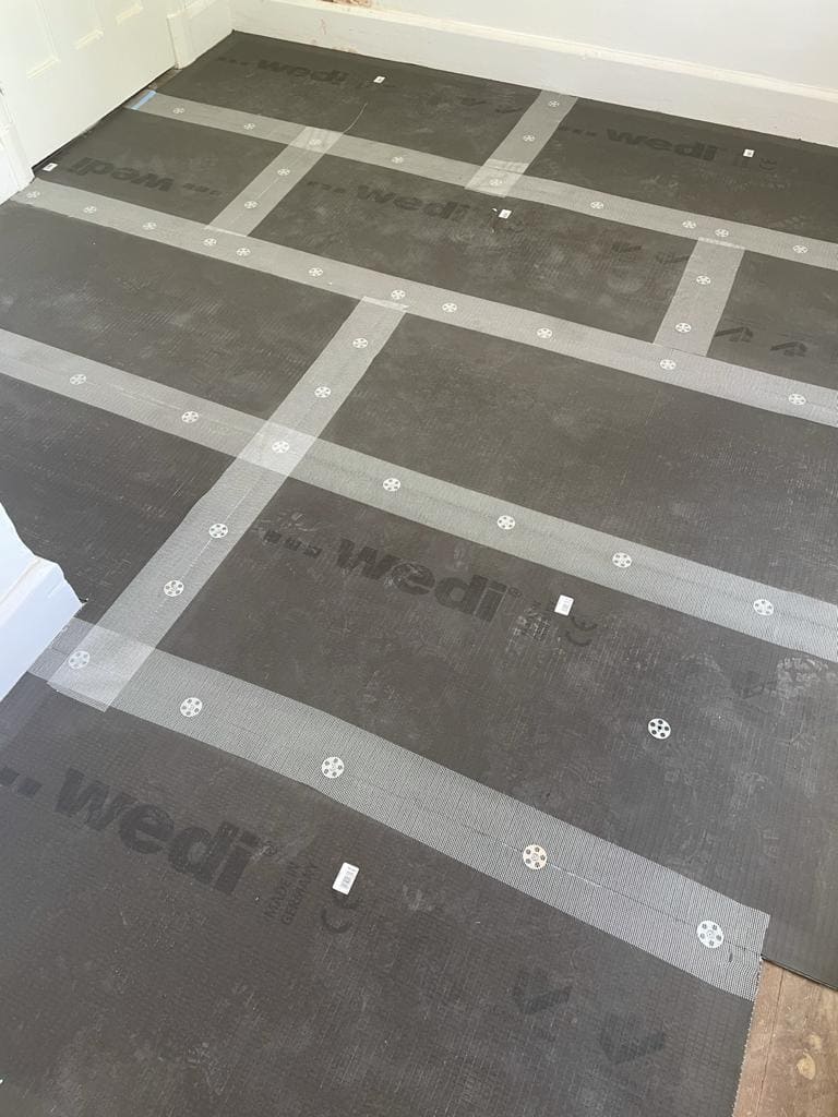 Bathroom floor waterproofing with Wedi tanking boards prior to tiling in a London property