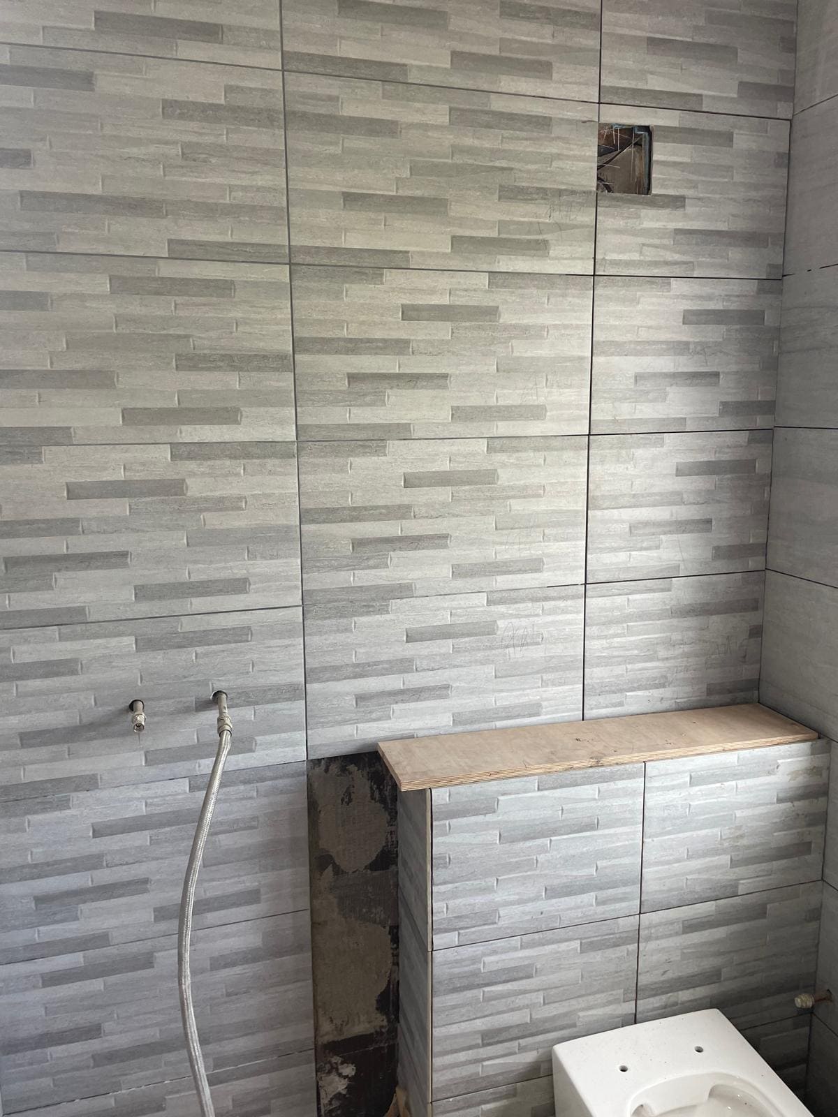 London bathroom mid-refurb with new tiling and plumbing being installed