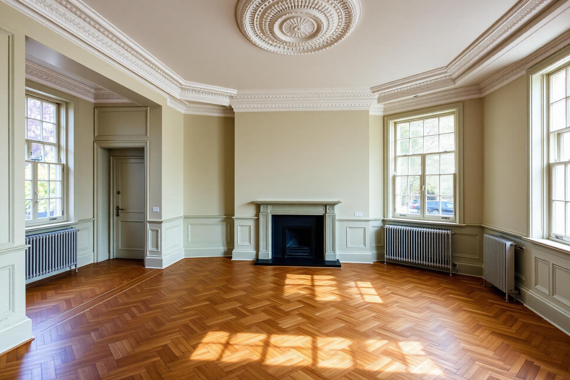 Fully renovated London townhouse reception room with restored cornicing, herringbone oak floor and painted sash windows
